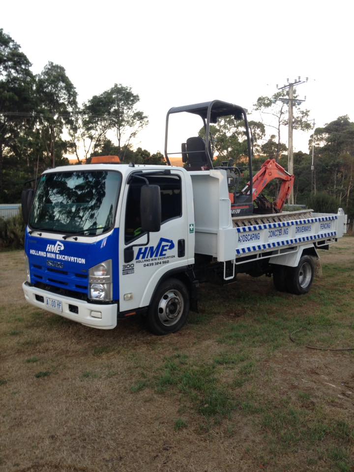 HME Holland Mini Excavation tipper truck with blue cab and tray decals